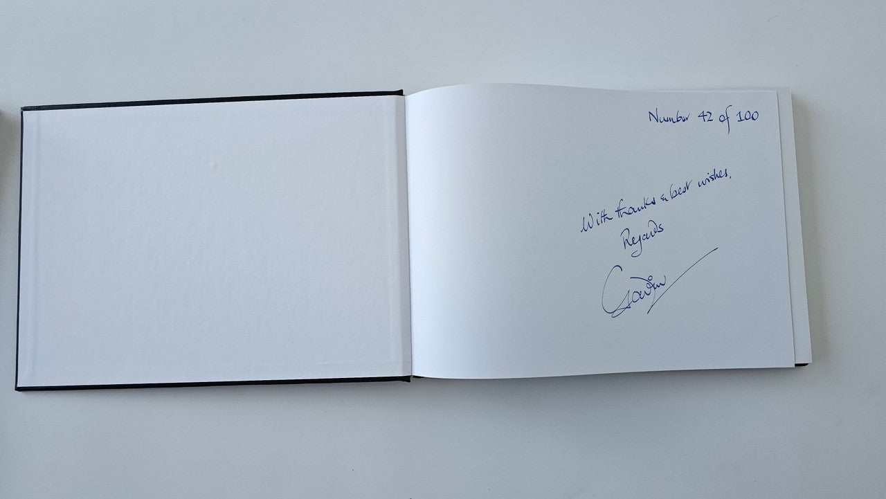 Open book with blank left page and handwritten signature on right page