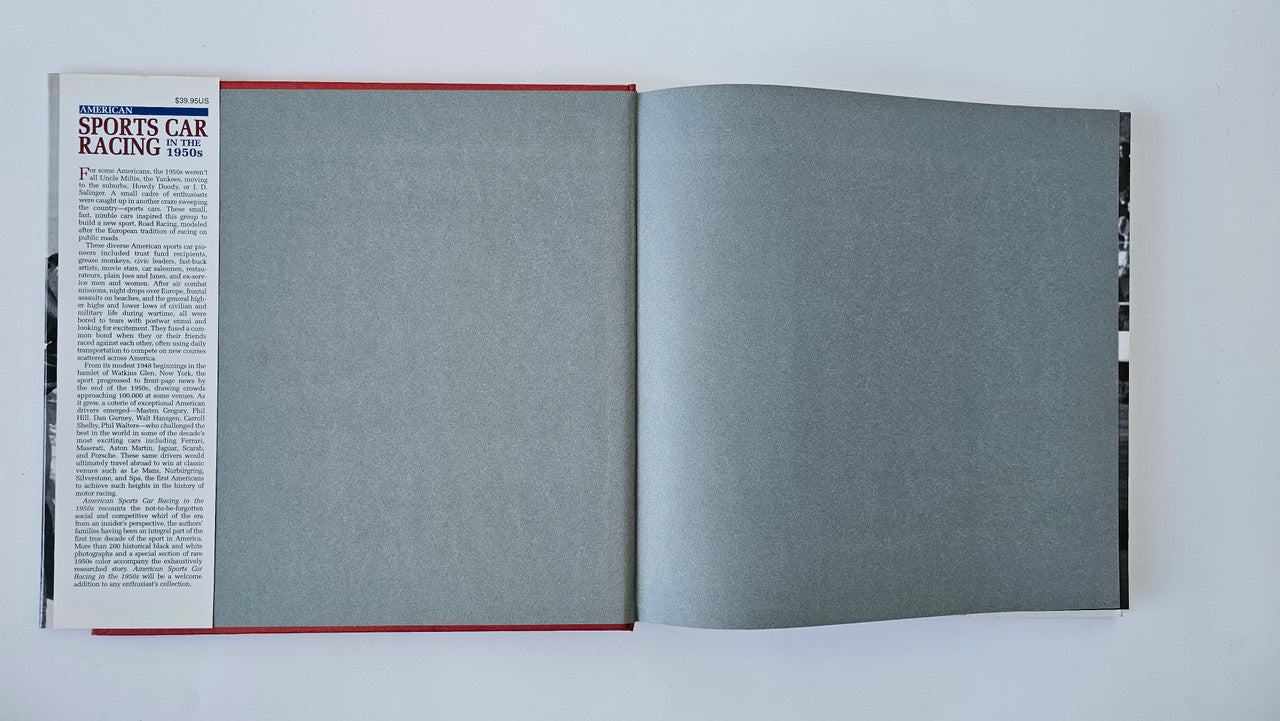 Open book showing gray pages with red trim along the left cover edge