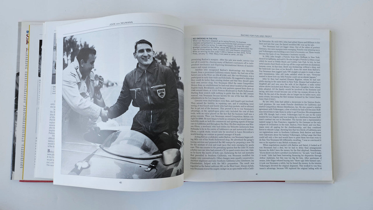 Open sports car racing book with black-and-white photo of people and text pages
