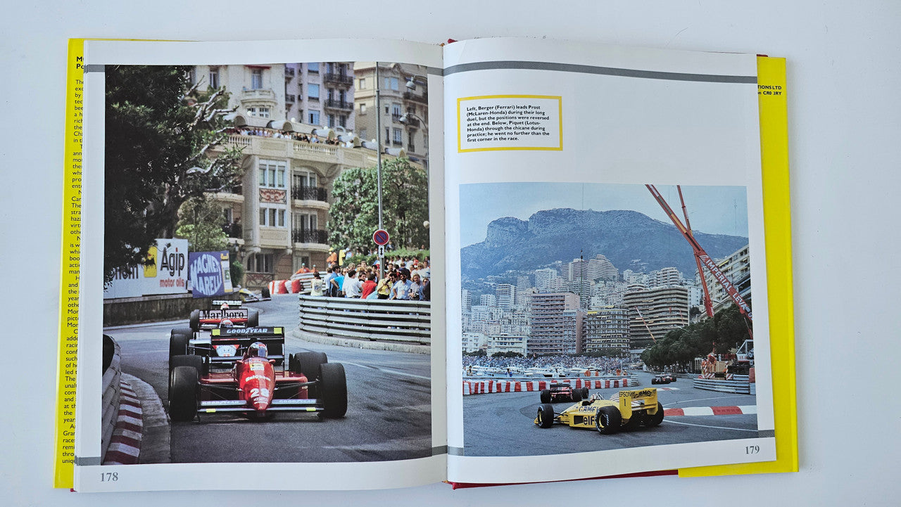 Open motorsport photo book with colorful vintage race cars, including yellow car on right