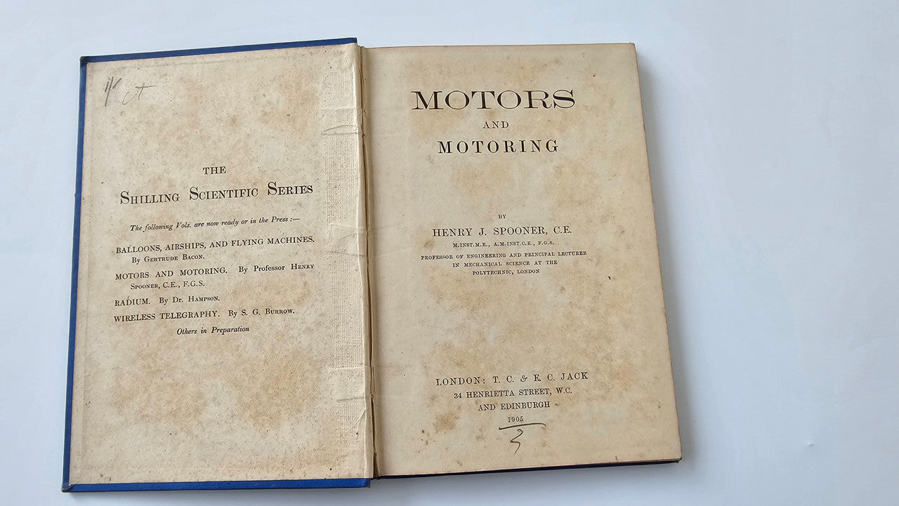 Motors and Motoring book open: title page text on two sheets
