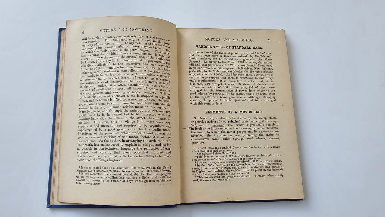 Motors and Motoring book open: dense text on two pages