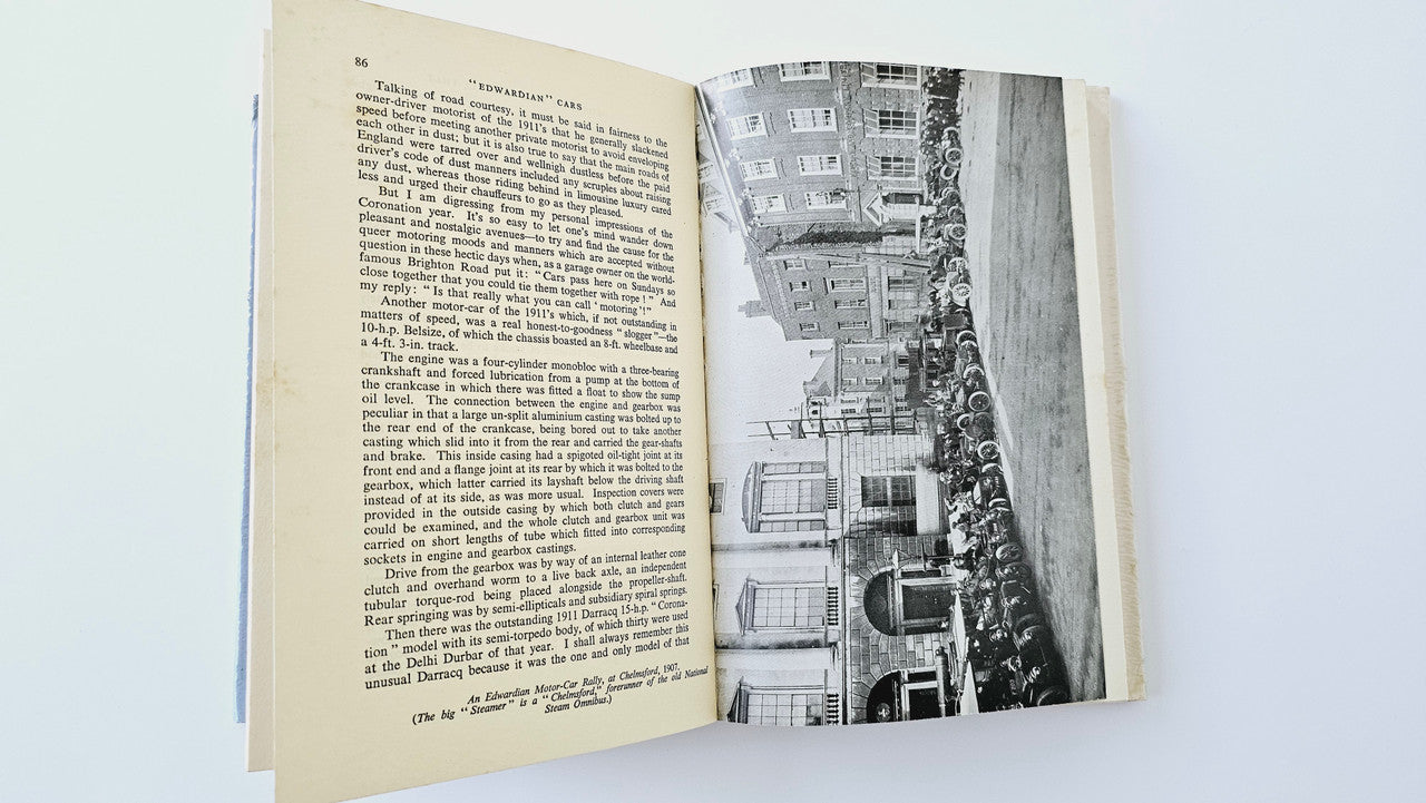 Open book with dense text pages and black-and-white car photo
