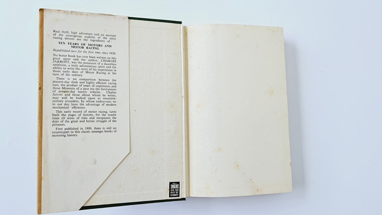 Open vintage book showing left page with printed text and right page blank.