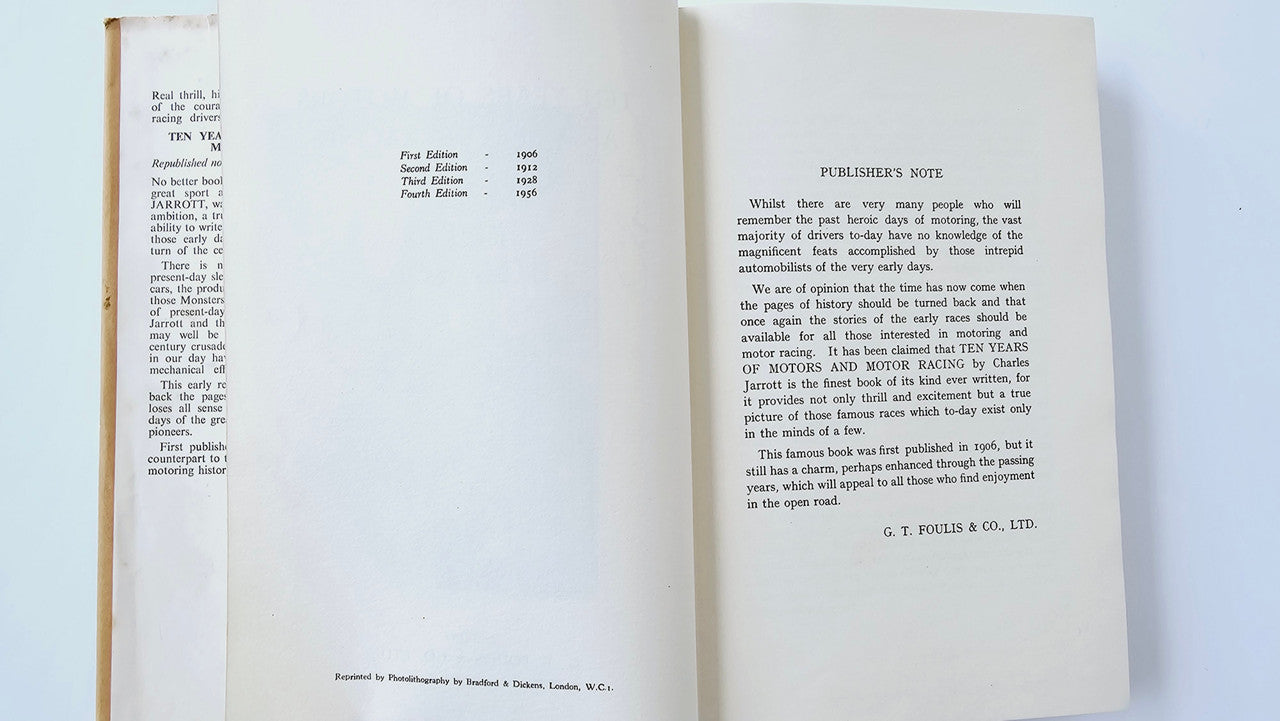 Open vintage book pages filled with small printed text and headings.