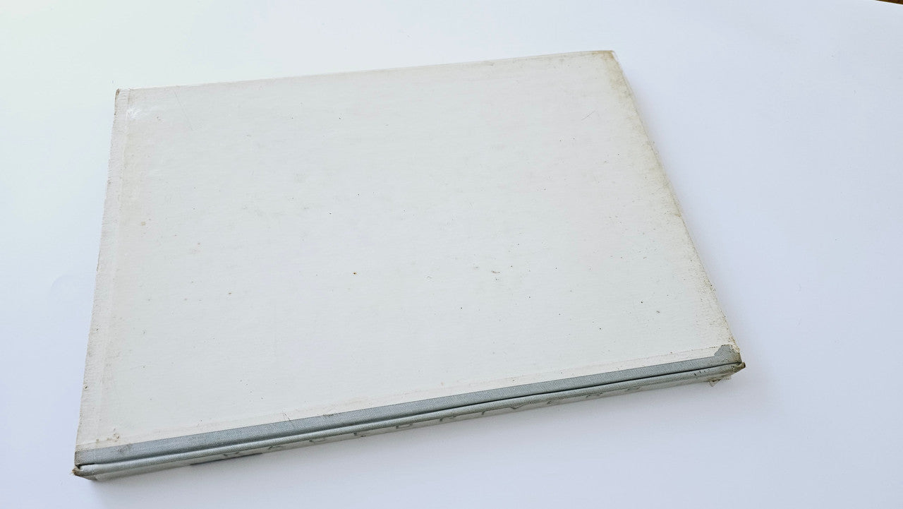 Vintage photo book back cover, plain off-white with worn edges