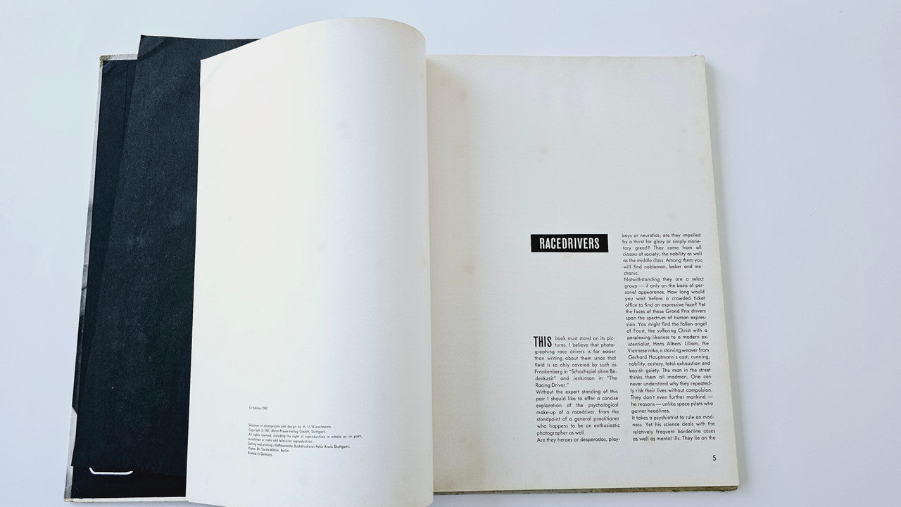 Open vintage photo book with text-heavy back pages and small race label