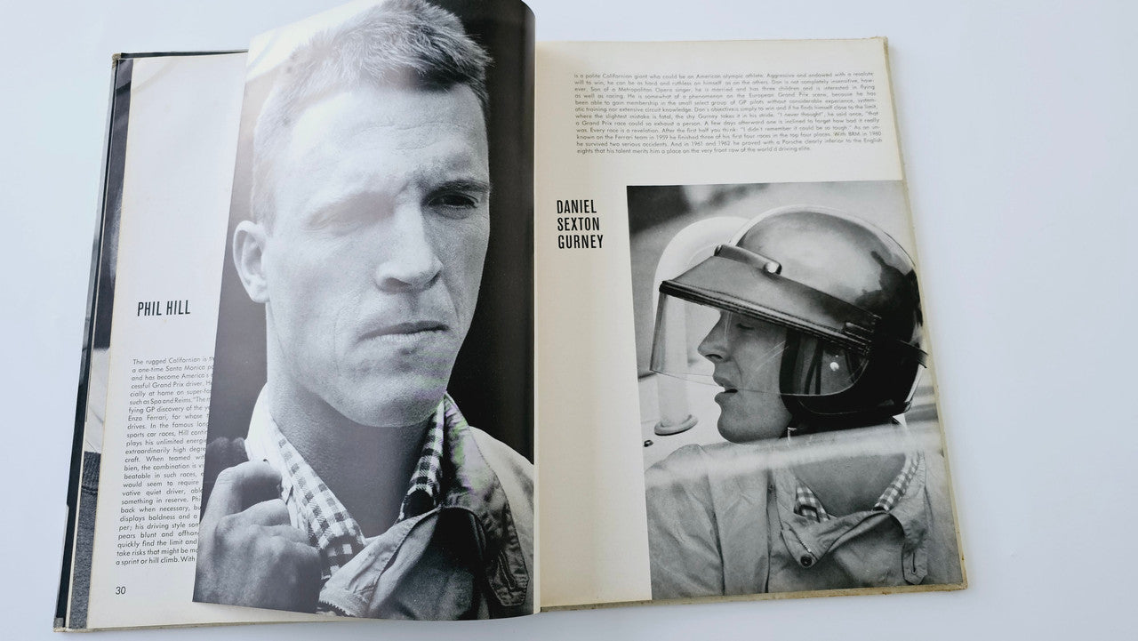 Open vintage auto racing book spread with driver portraits and captions
