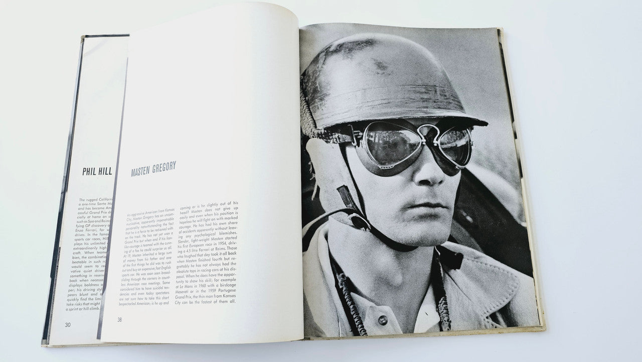 Open vintage auto racing book spread featuring helmeted driver close-up photo