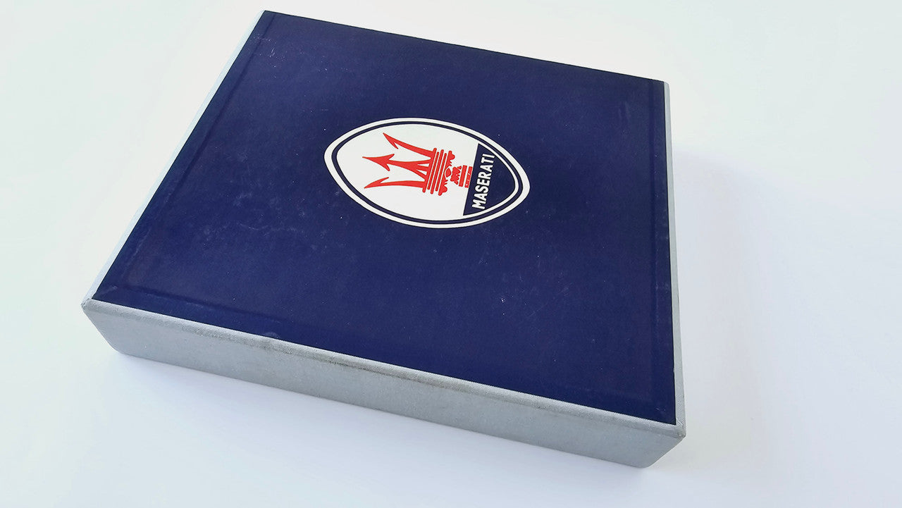 Maserati history book in blue slipcase with red trident logo