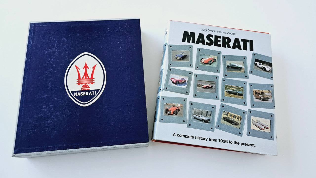Maserati history book with blue logo cover and boxed photo-card set