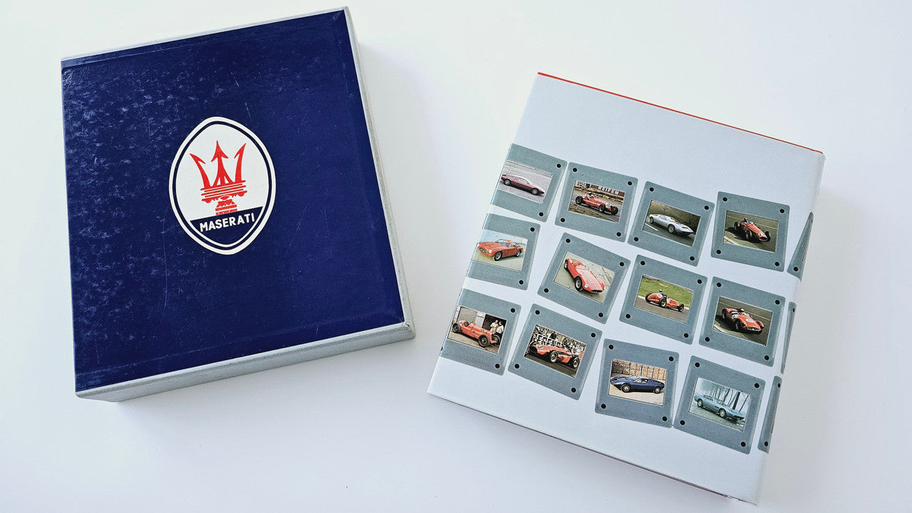 Maserati history book set with blue cover and a grid of vehicle photo cards