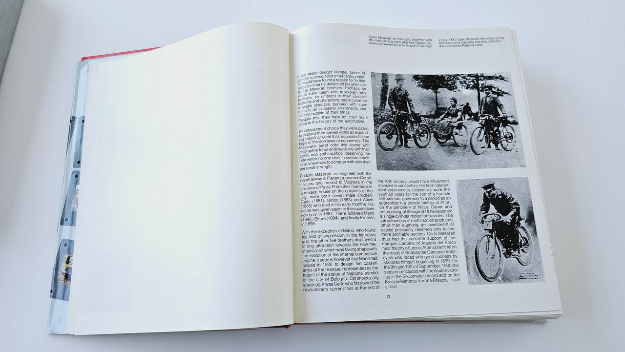 Maserati history book open to black-and-white motorcycle photo pages
