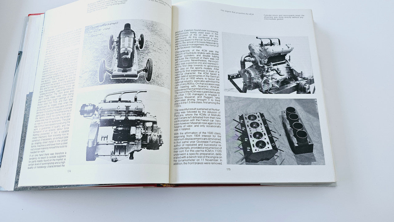 Classic car history book open to engine detail photos and captions
