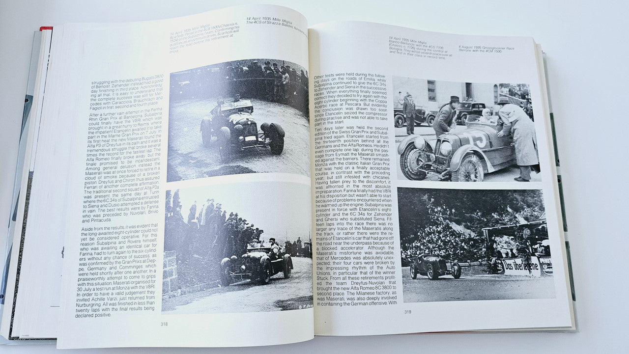 Classic car history book open to vintage racing and workshop photos