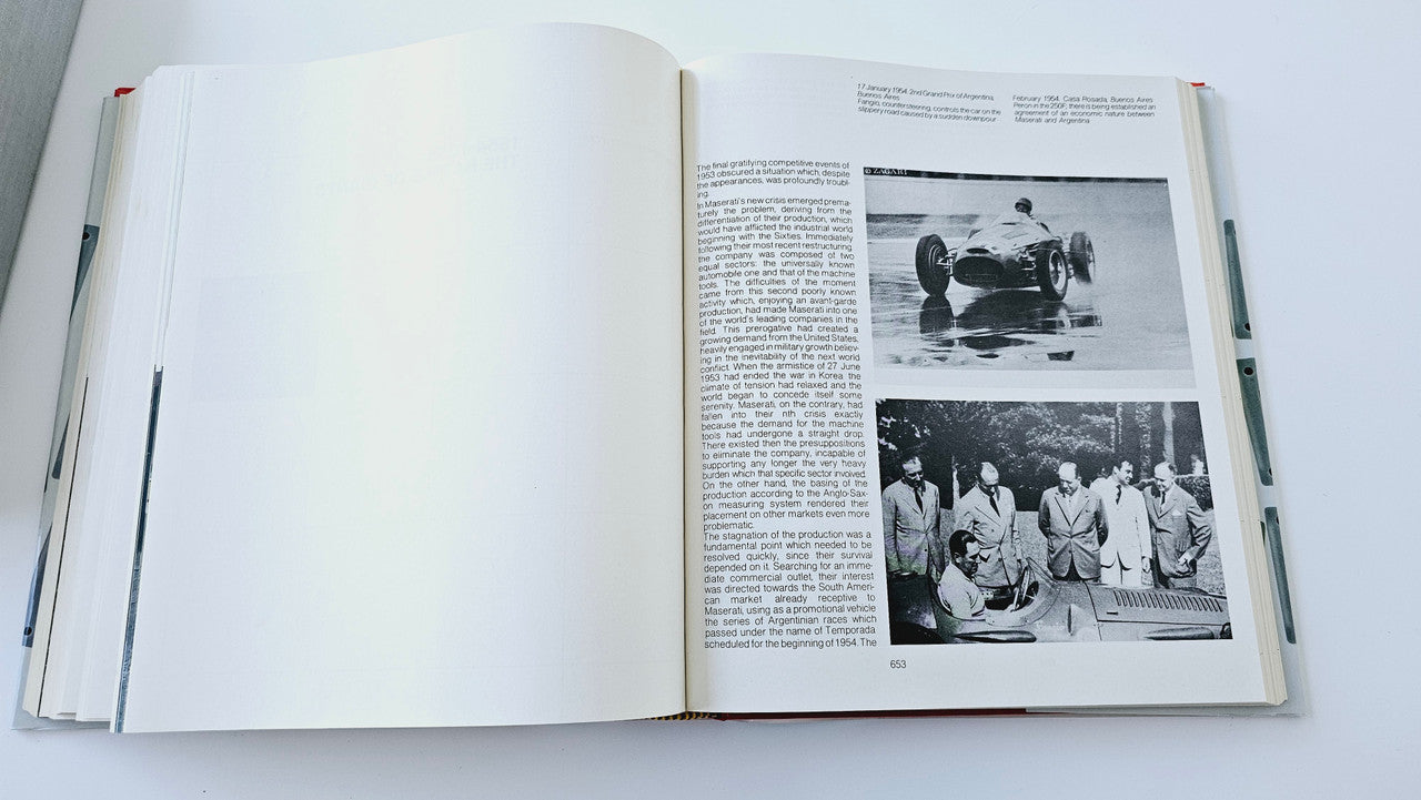 Maserati history book open to text with black-and-white photo pages