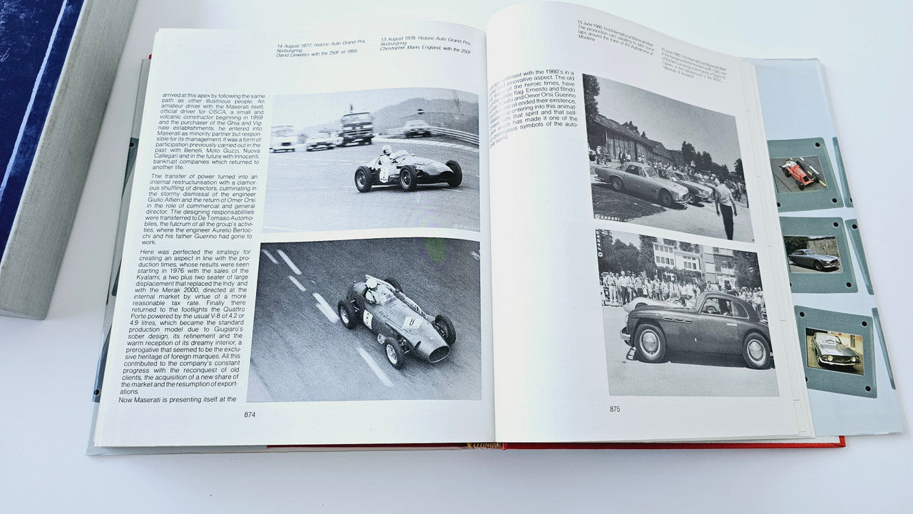 Classic car history book open to black-and-white car and track photos