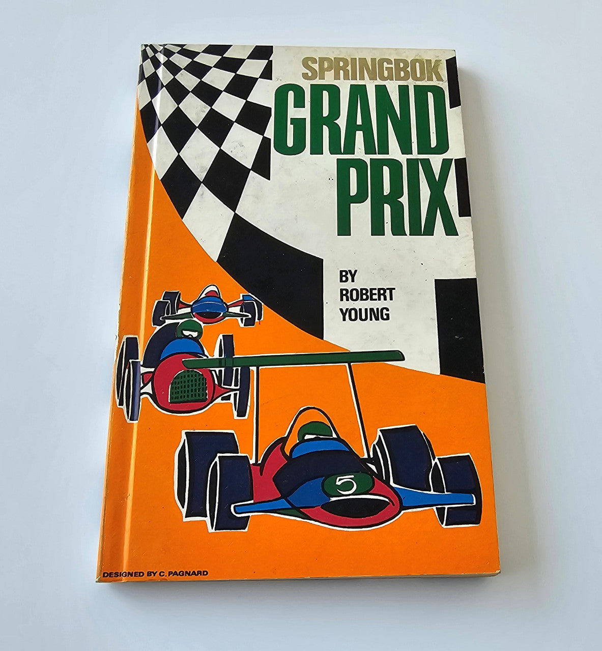 Motorsport book cover with orange background, illustrated racecar, and large title text.