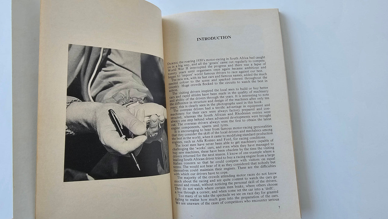 Motorsport book open to an introduction page with a black-and-white photo insert.