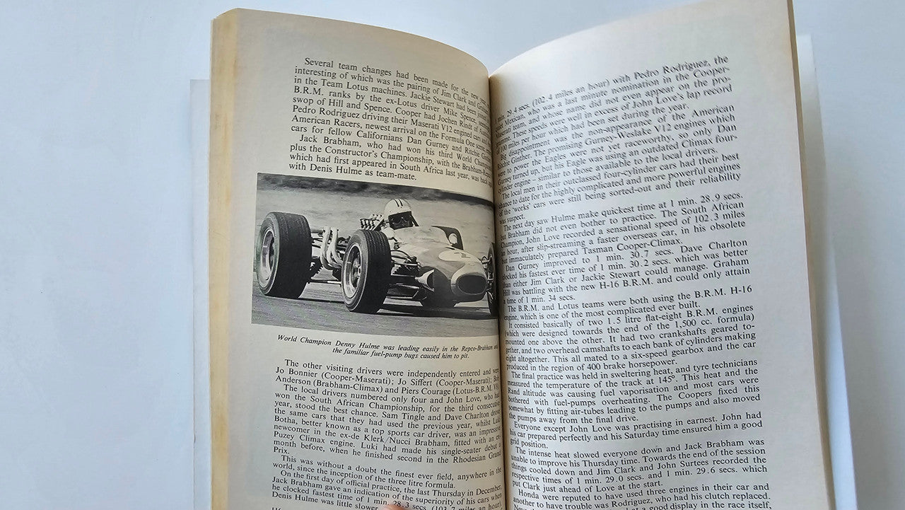 Motorsport book open to a spread with racecar photo on the left and text on the right.