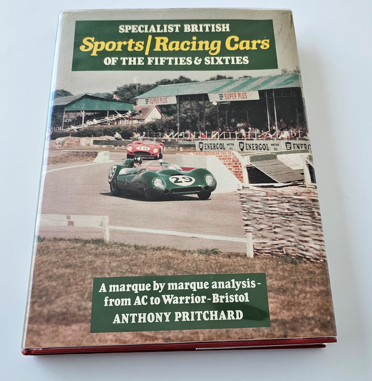 Paperback book cover showing classic racing cars and large title text
