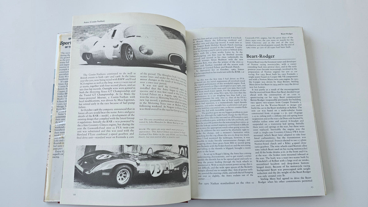 Open book spread with two racing car photos and surrounding text
