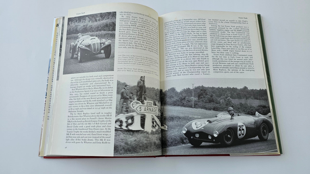 Sports racing book open with two-page spread of black-and-white race cars