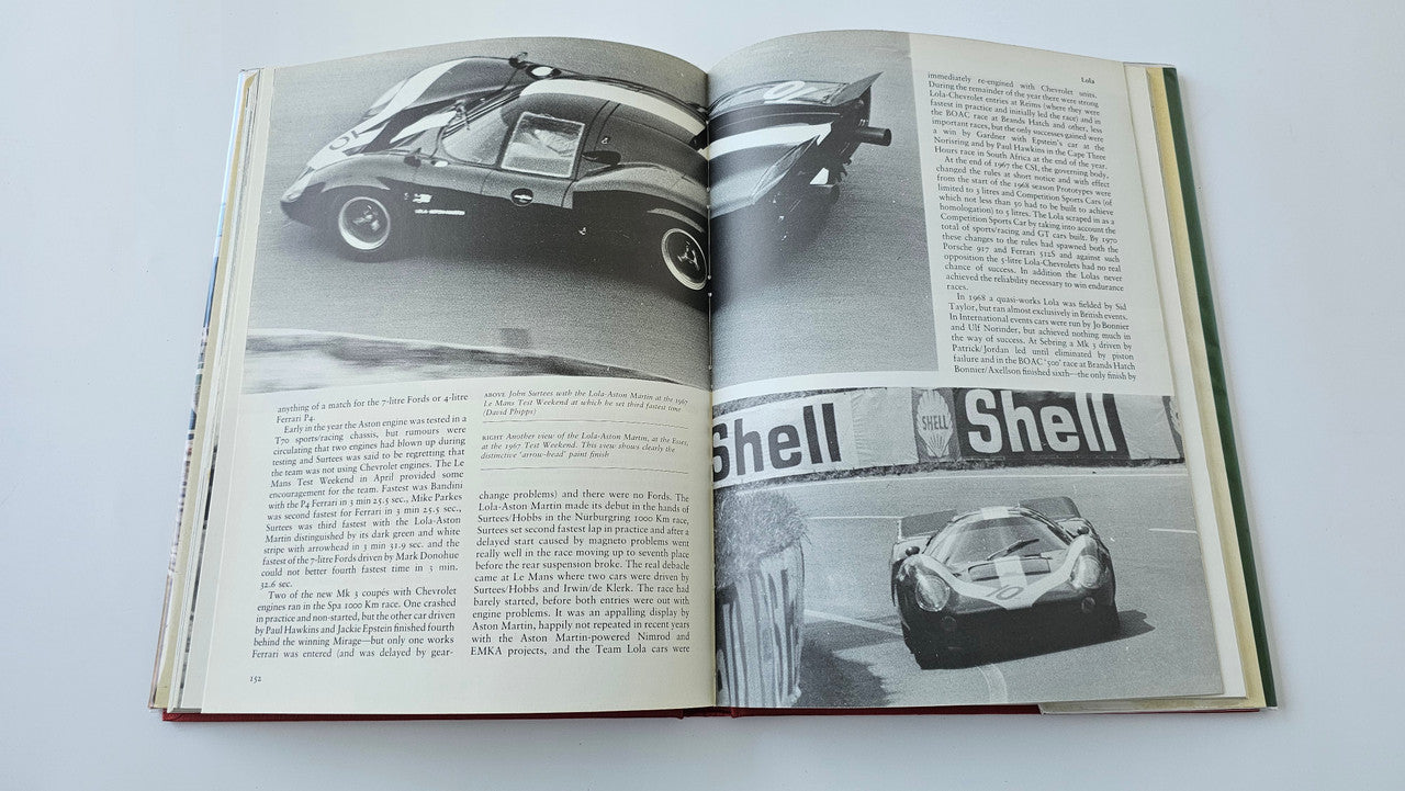 Sports racing book open with colorless car photos and Shell graphic on page