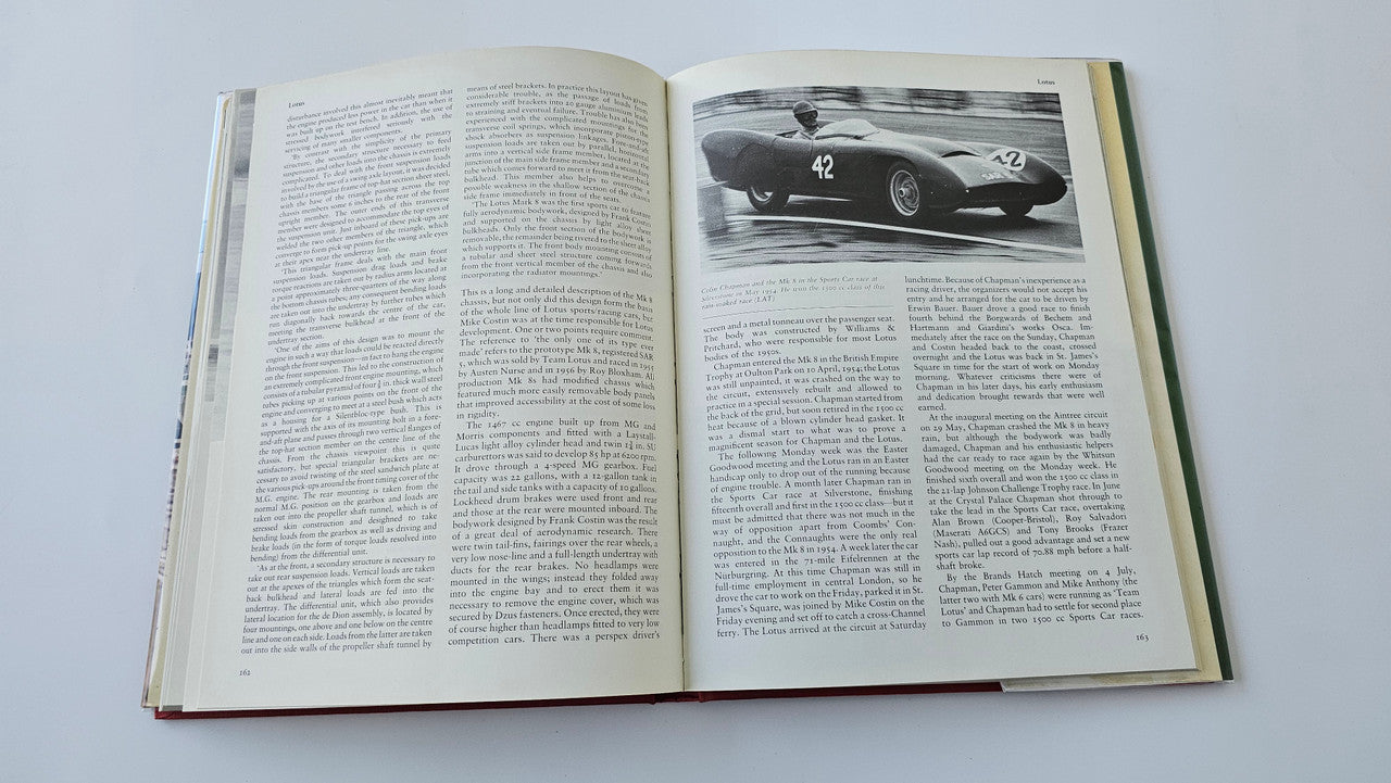 Sports racing book open with grayscale race car photo and dense text