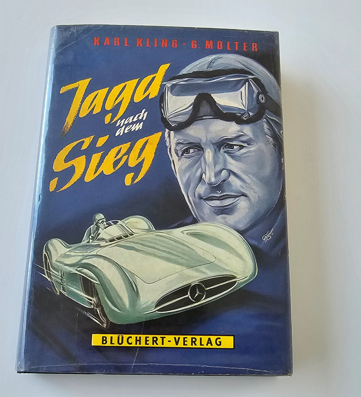 Chasing Victory hardcover book with illustrated racing car and helmet portrait cover
