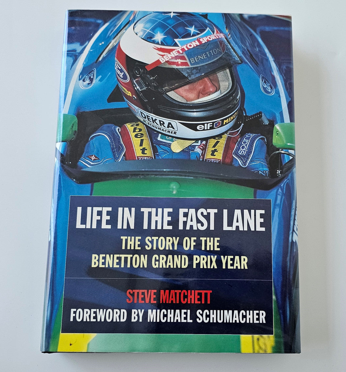 Signed motorsport biography book, front cover with Benetton Grand Prix title