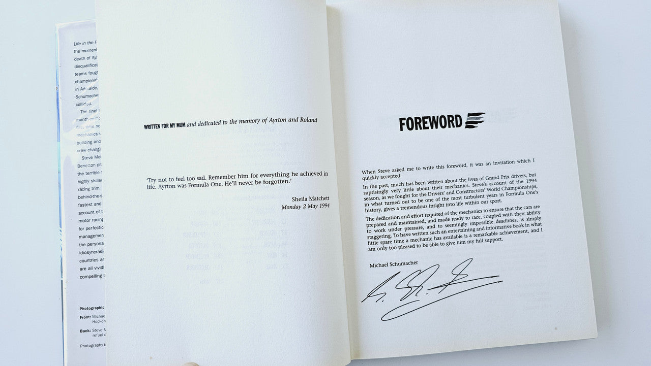 Book spread with foreword text and signed note on the right page