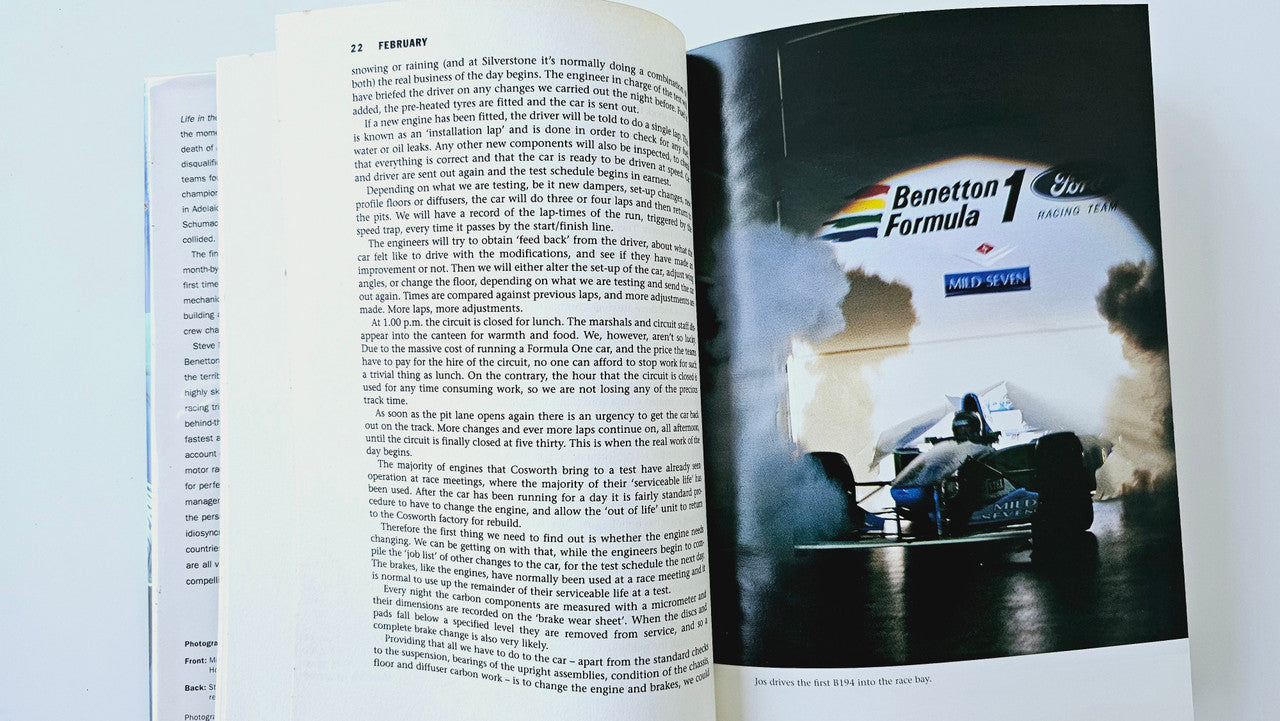 Open book with printed text and Benetton Formula 1 racing photo spread