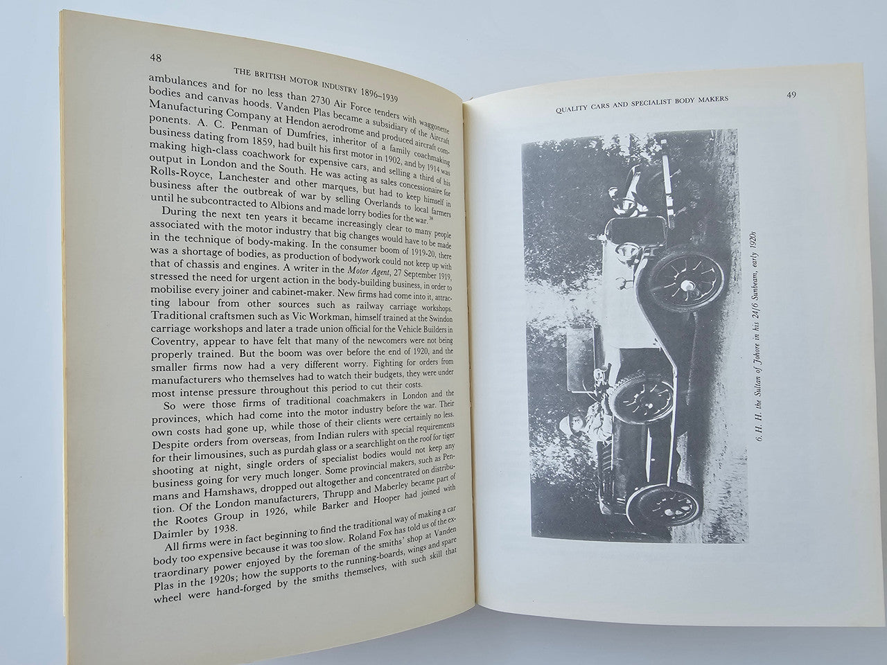 Book open spread with chapter text on the left and a car photo illustration