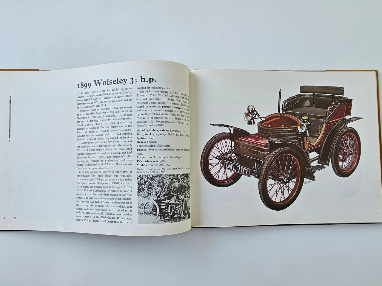 Open vintage motoring history book page with 1899 Wolseley car illustration and text