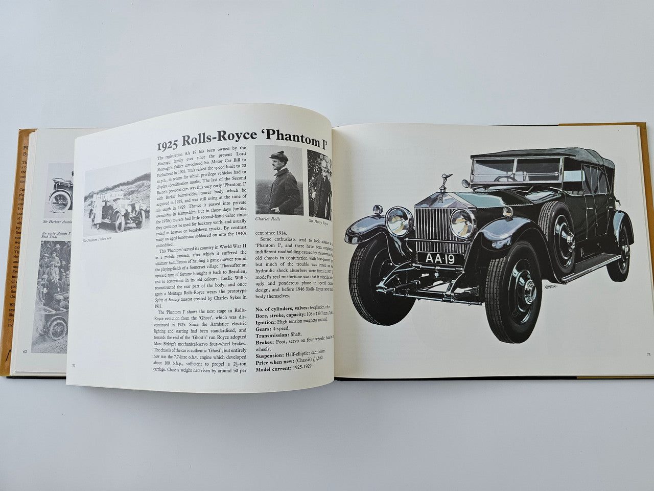 Open vintage automotive history book with 1925 Rolls-Royce Phantom II text and black car illustration