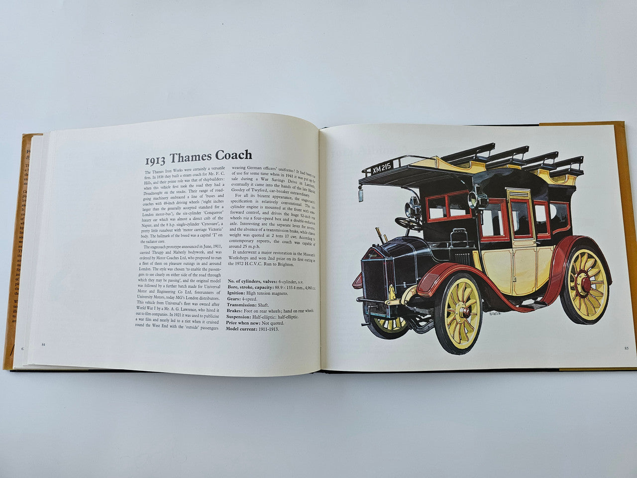 Open vintage automotive history book with 1913 Thames Coach text and illustrated carriage