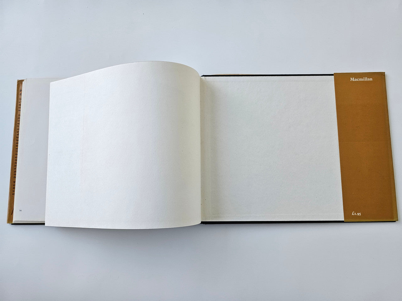 Vintage motoring history book with two blank pages facing up