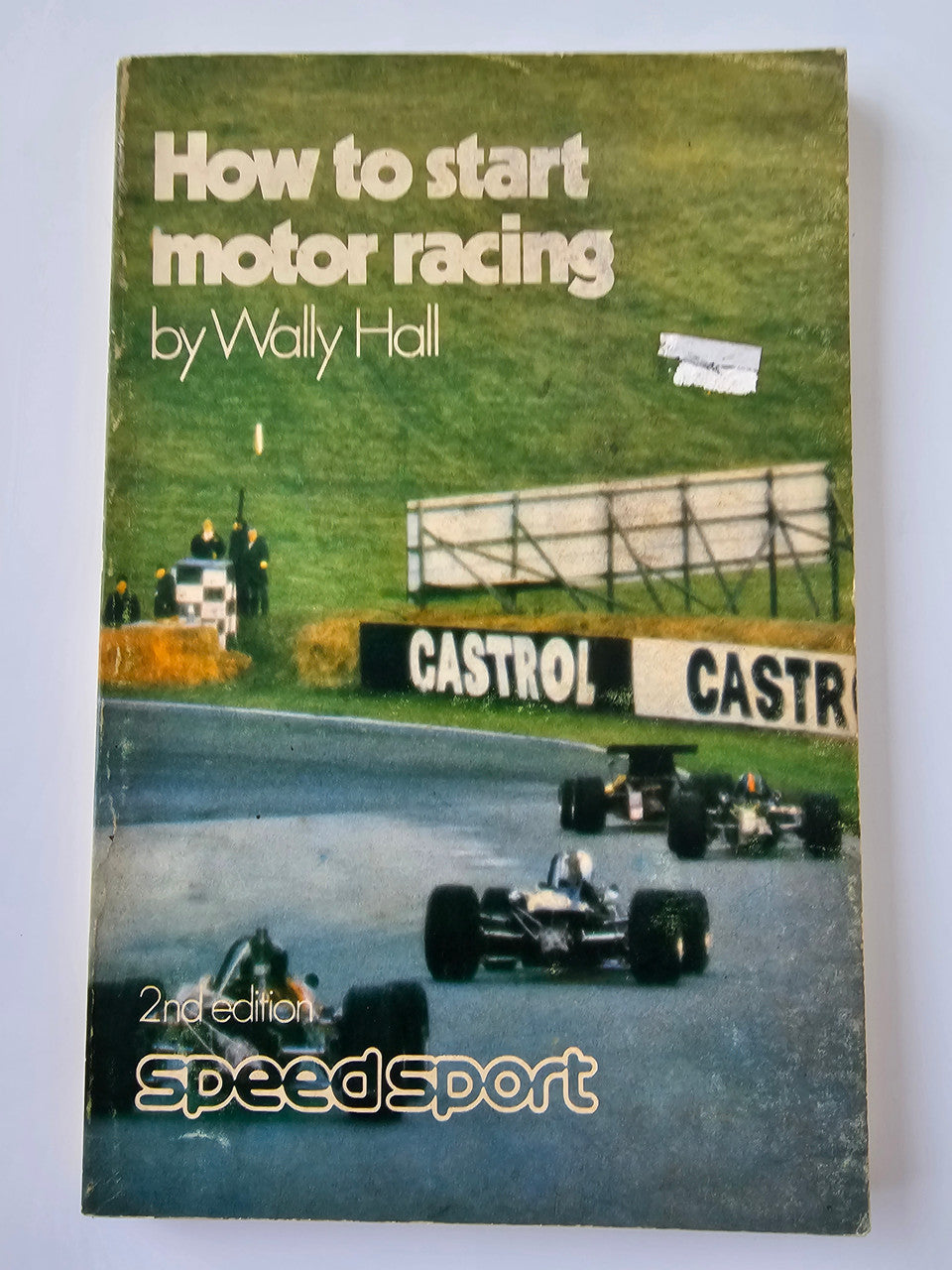 Motor racing guide paperback cover with car on track and "2nd edition" text