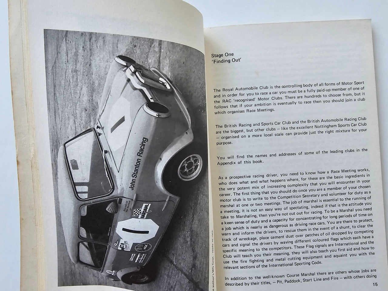 Motor racing guide book open to a black-and-white photo of a race car