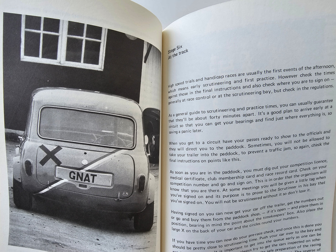 Motor racing guide book open to a black-and-white photo of a vintage car