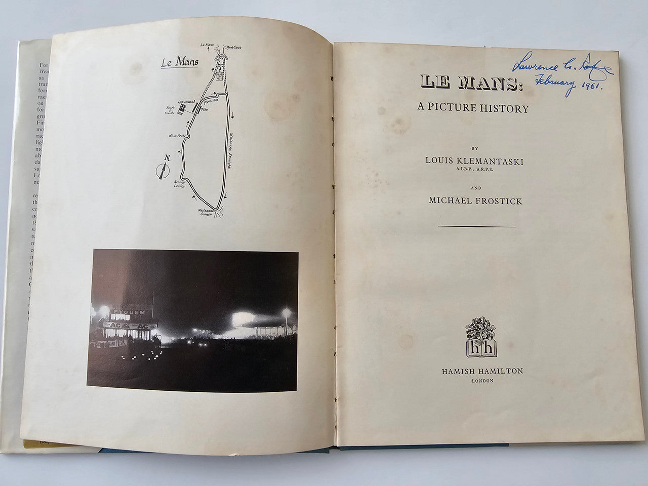 Vintage motoring history book open to title pages with diagram and cover text