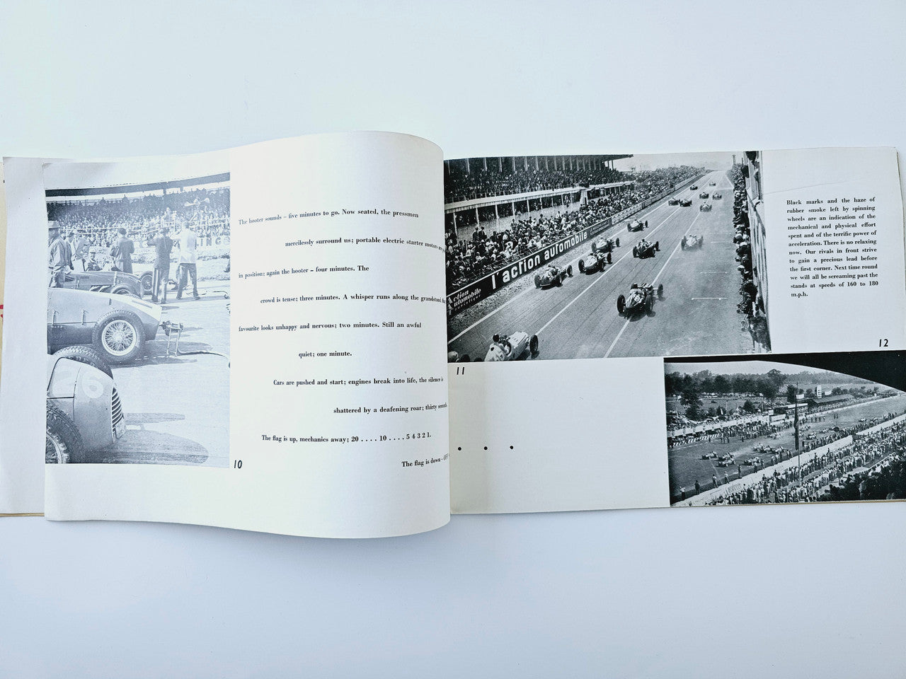 Open motor racing book spread with black-and-white photos of track action and crowds.