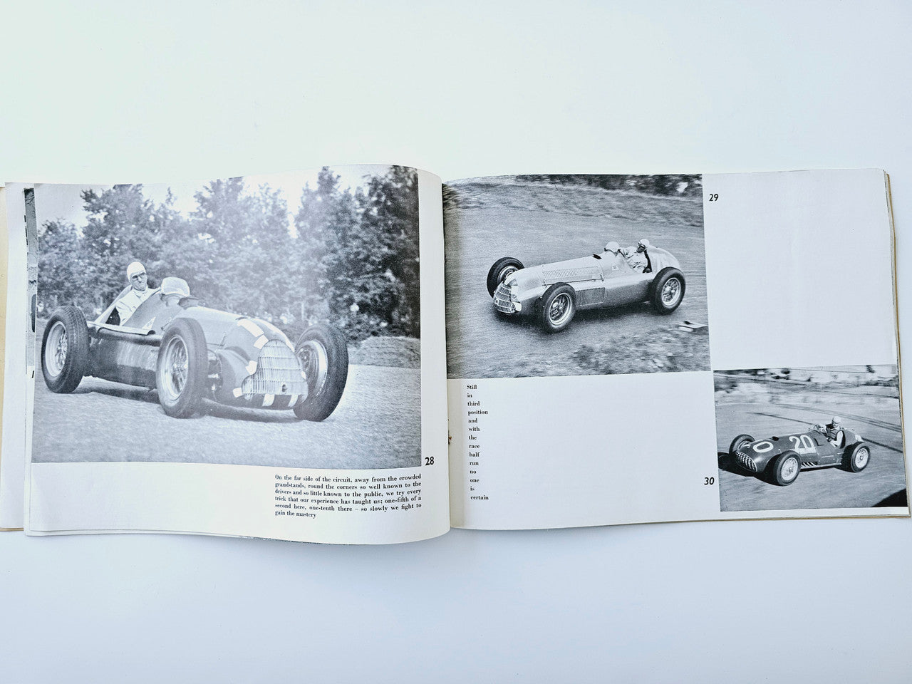 Open book spread with black-and-white photos of racing cars on track and grass.