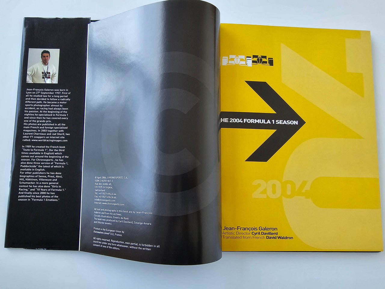 Open guidebook pages with black biography panel and yellow title graphic
