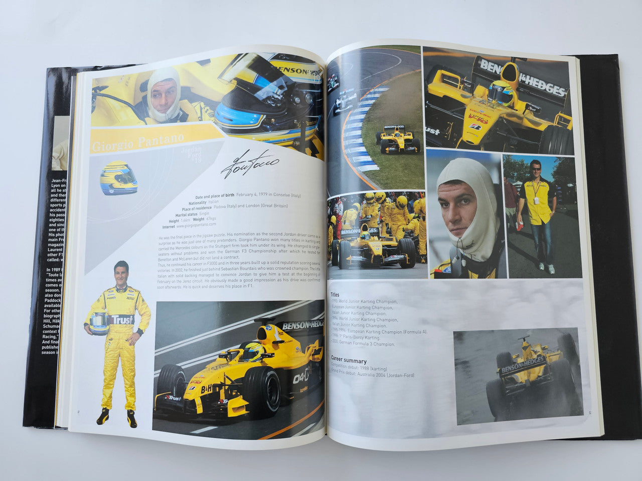 Open guidebook spread with yellow racing scenes, driver portrait, and captions