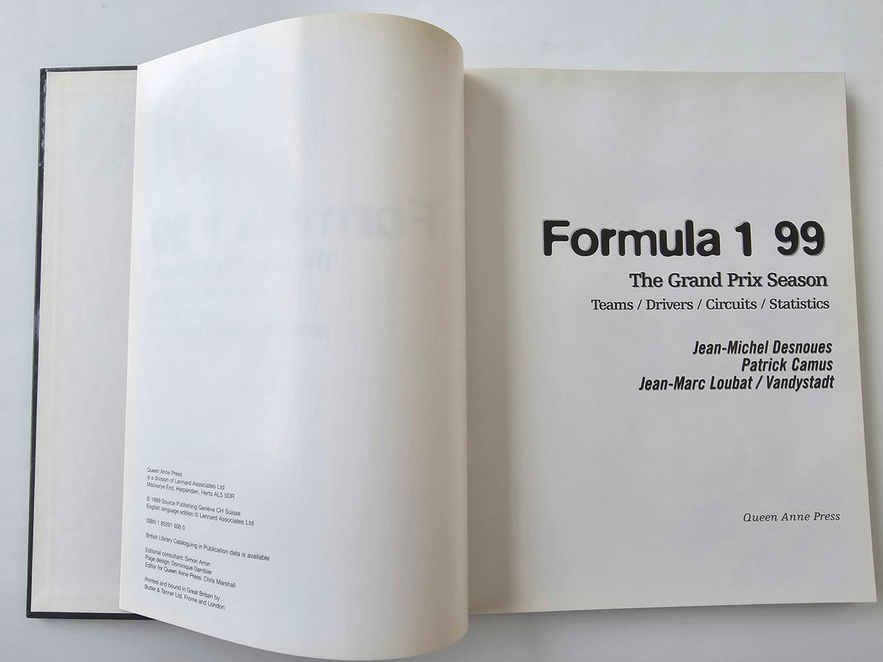 Hardcover racing season book opened to title and author information pages