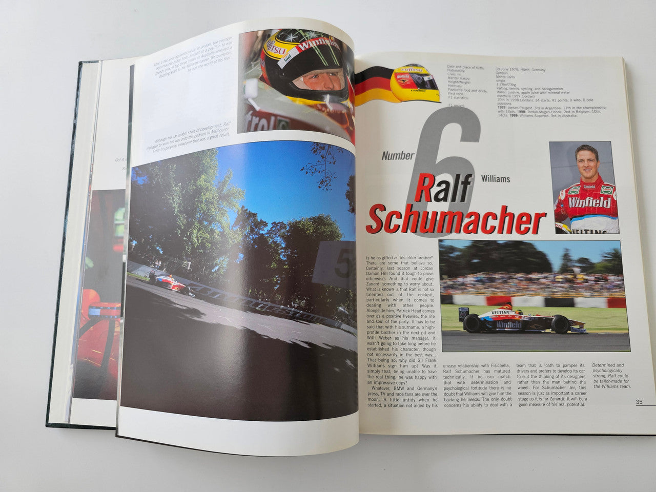 Racing season book opened to Ralf Schumacher profile page with car photo