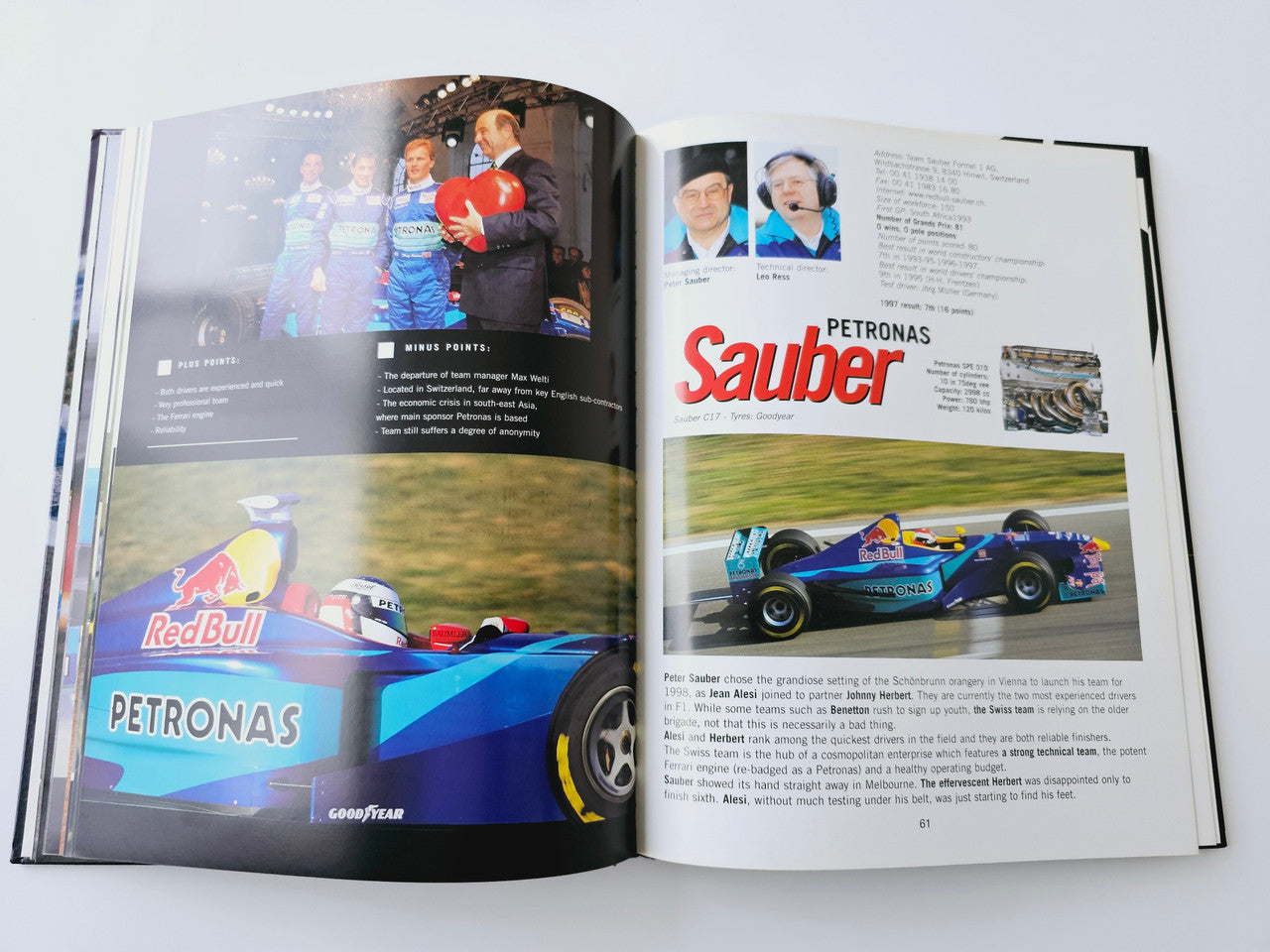 Team history spread featuring Petronas Sauber page with car action photo