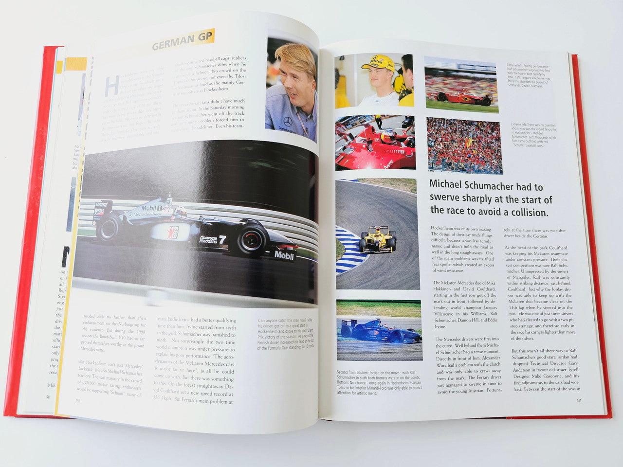 Open German GP book spread with car close-up photo and racing commentary text